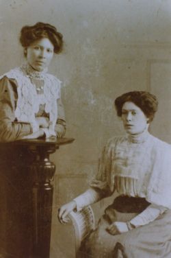 Caroline (Carrie) standing at left, and sitting is Louisa Wood